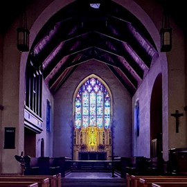 A religious procession with altar servers carrying candles and incense at an altar, in church.