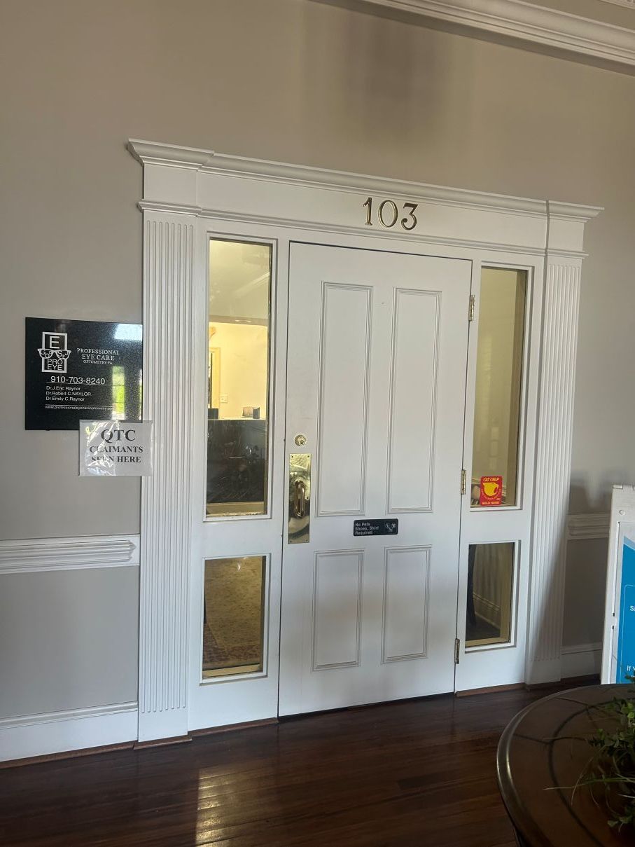 White double front door with sidelights in a hallway, marked 813 in Eastover, NC.