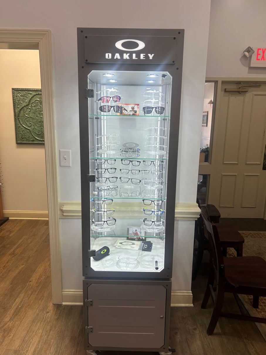 Tall glass beverage cooler with shelves, in an indoor lobby or hallway in Eastover, NC.