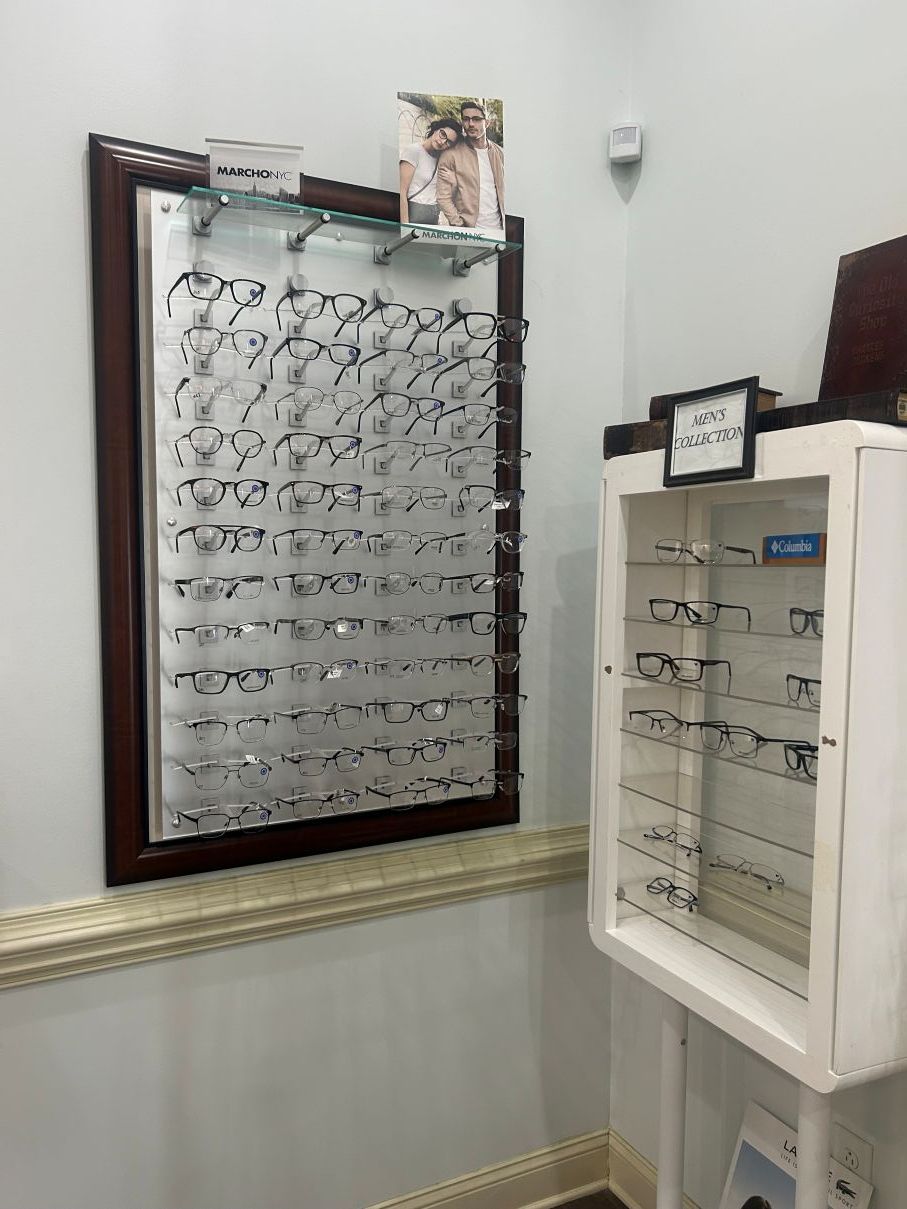 Eyeglass display in a store, with framed eyeglass samples on a wall and a white display case in Eastover, NC.