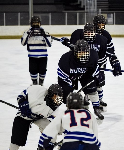 A hockey player with the number 12 on the back of his jersey