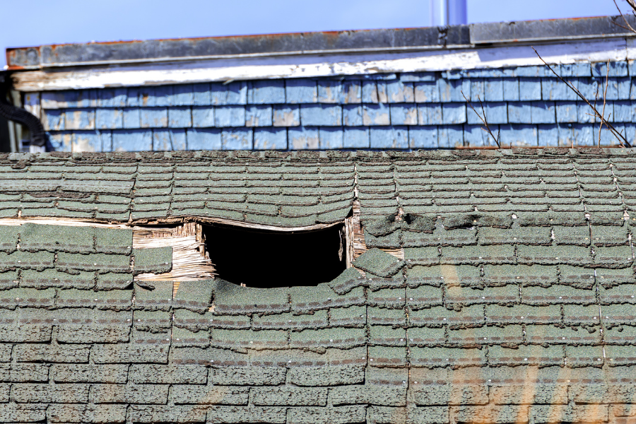 Damaged roof showing various types of weather-related damage