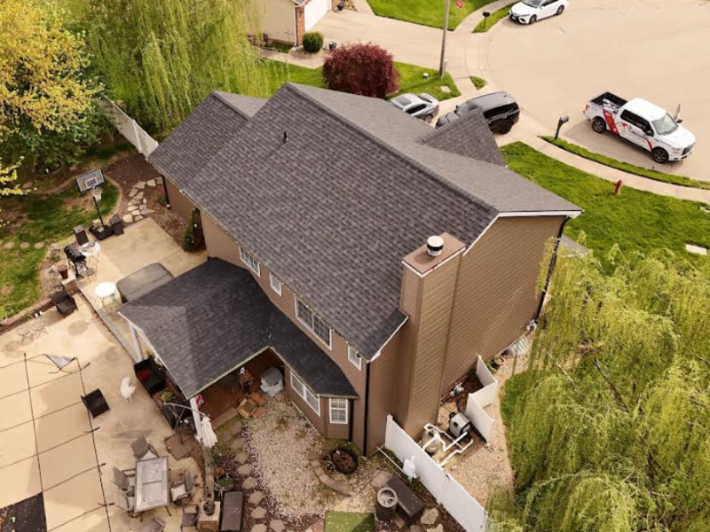 Aerial view of storm-damaged home showing compromised roofing