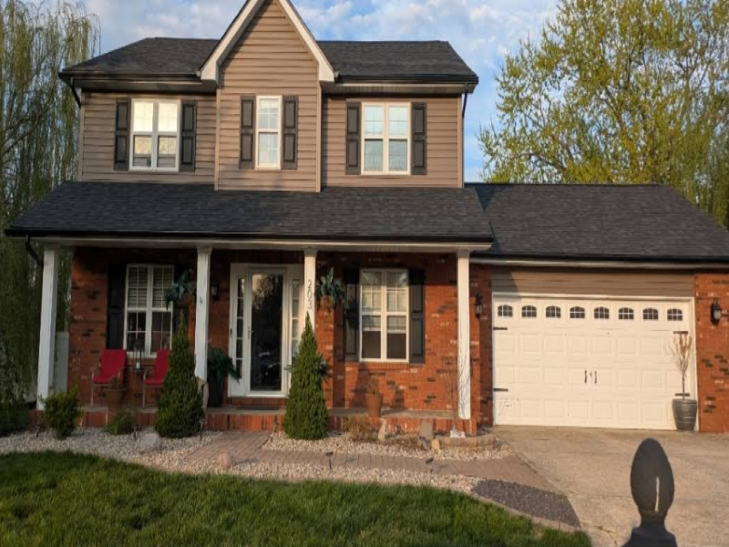Finished home restoration showing beautiful new roof and exterior