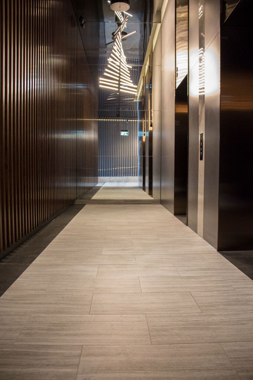Hallway In Commercial Building With Brown Modern Tiles — Hunter Valley Tile Mart in Rutherford, NSW