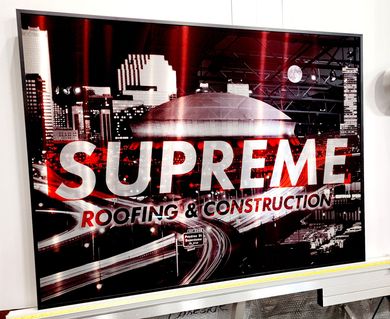 Red and black banner reading “SUPREME ROOFING & CONSTRUCTION” with city skyline graphics