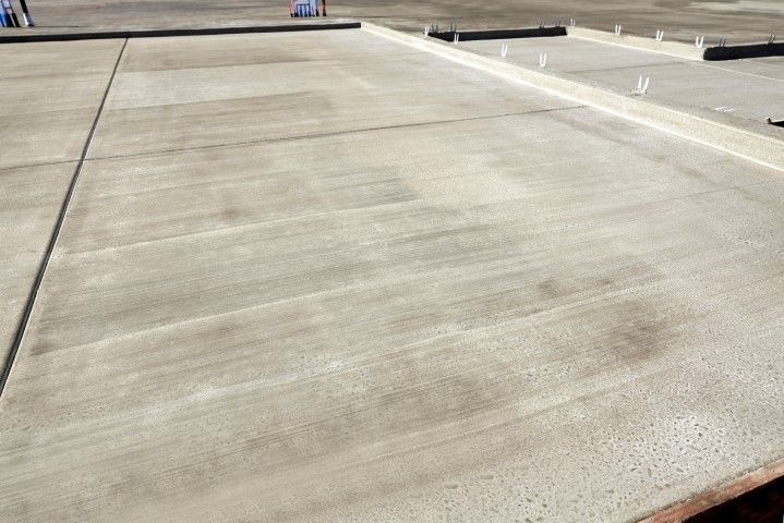 Newly poured concrete surface with visible smoothing lines.