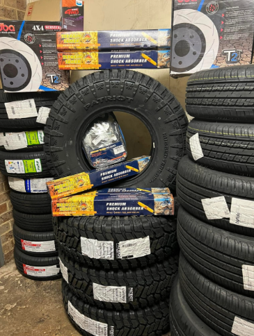 A Close Up of a Car Tire With a Stack of Tires in the Background — Jim Wall Automotive in Mittagong, NSW