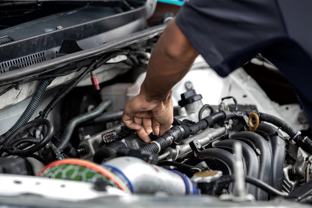 A Man is Working on the Engine of a Car — Jim Wall Automotive in Mittagong, NSW
