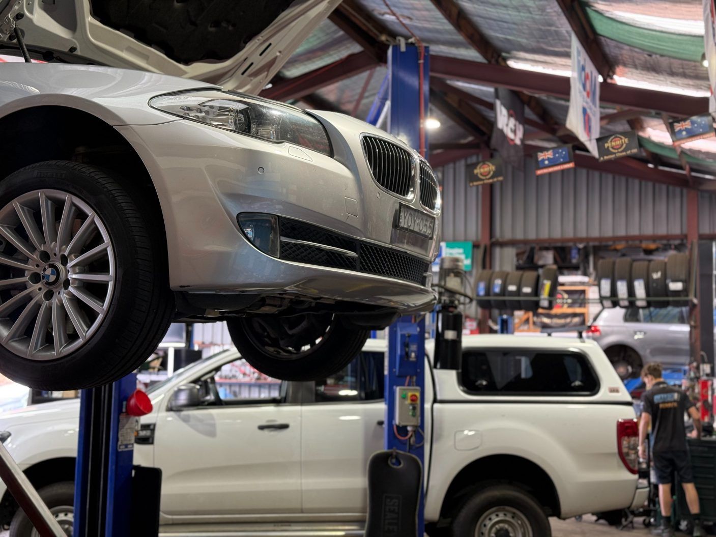 A Car is Sitting on a Lift in a Garage — Jim Wall Automotive in Mittagong, NSW
