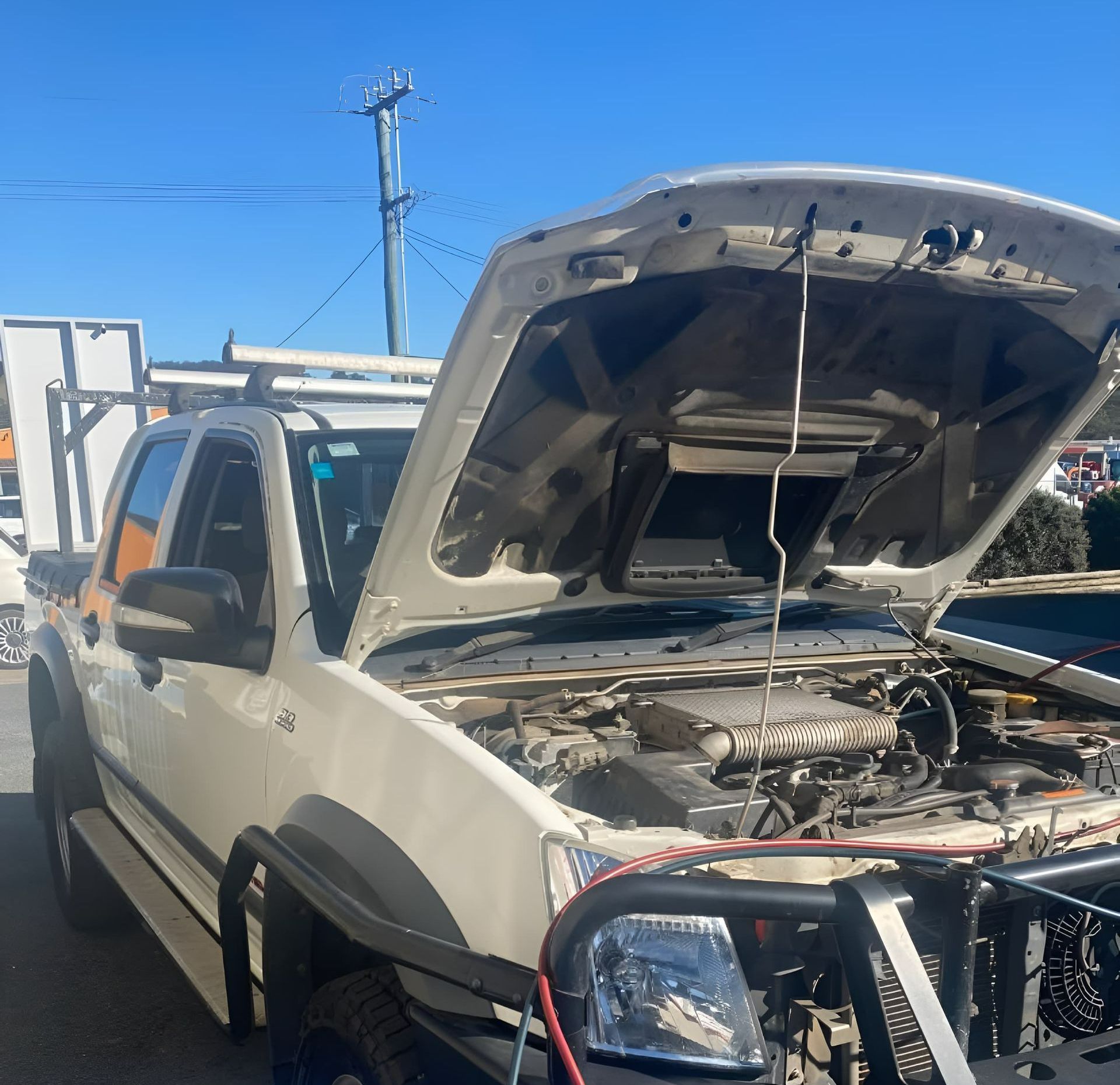 A white ute hood is open  — Jim Wall Automotive in Bowral, NSW