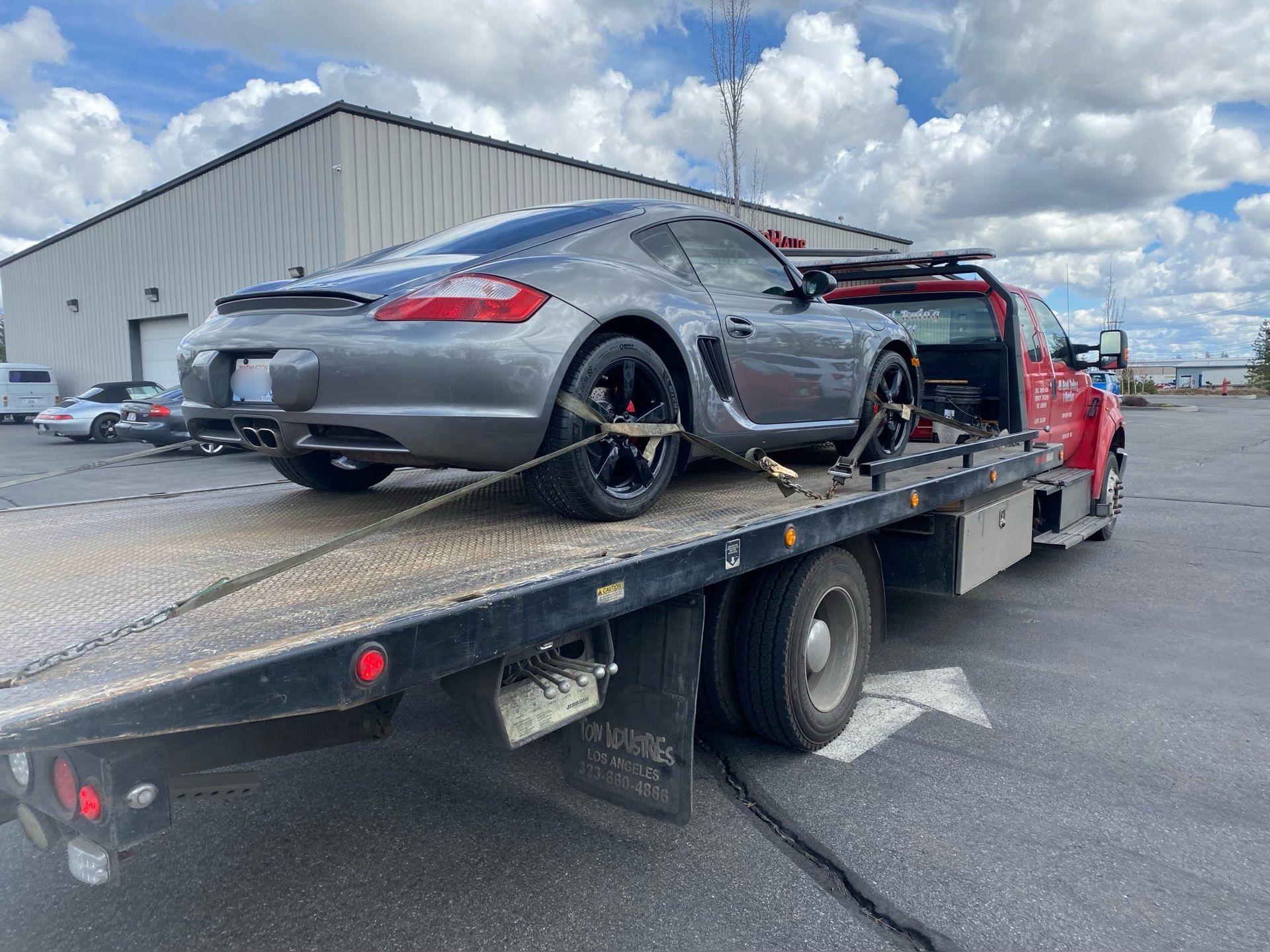 A car is sitting on top of a tow truck.