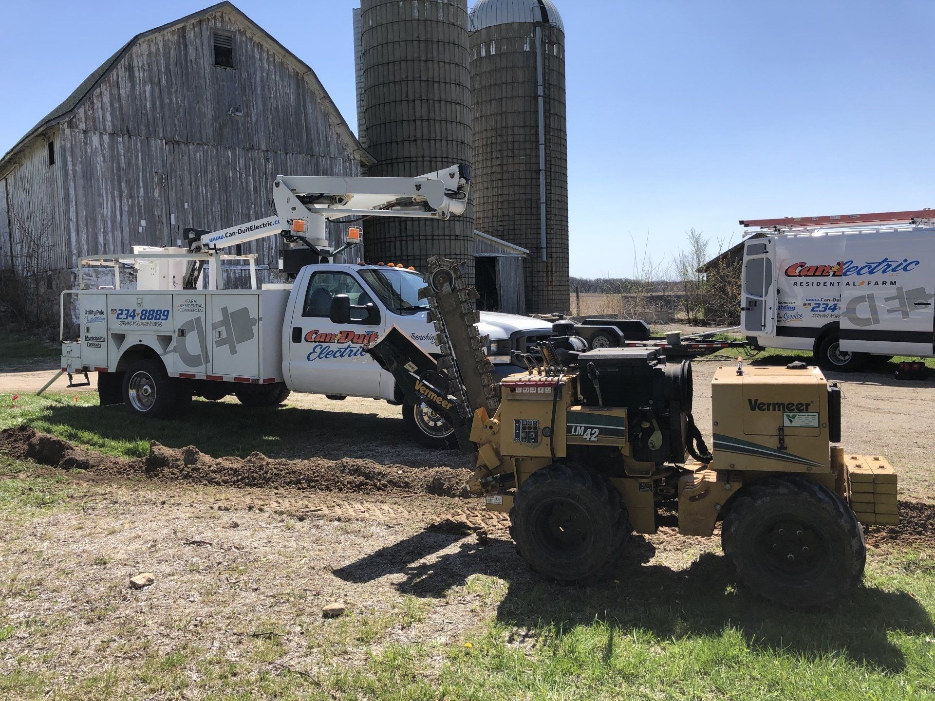 A man is fixing a drain in a bathroom with a hose.