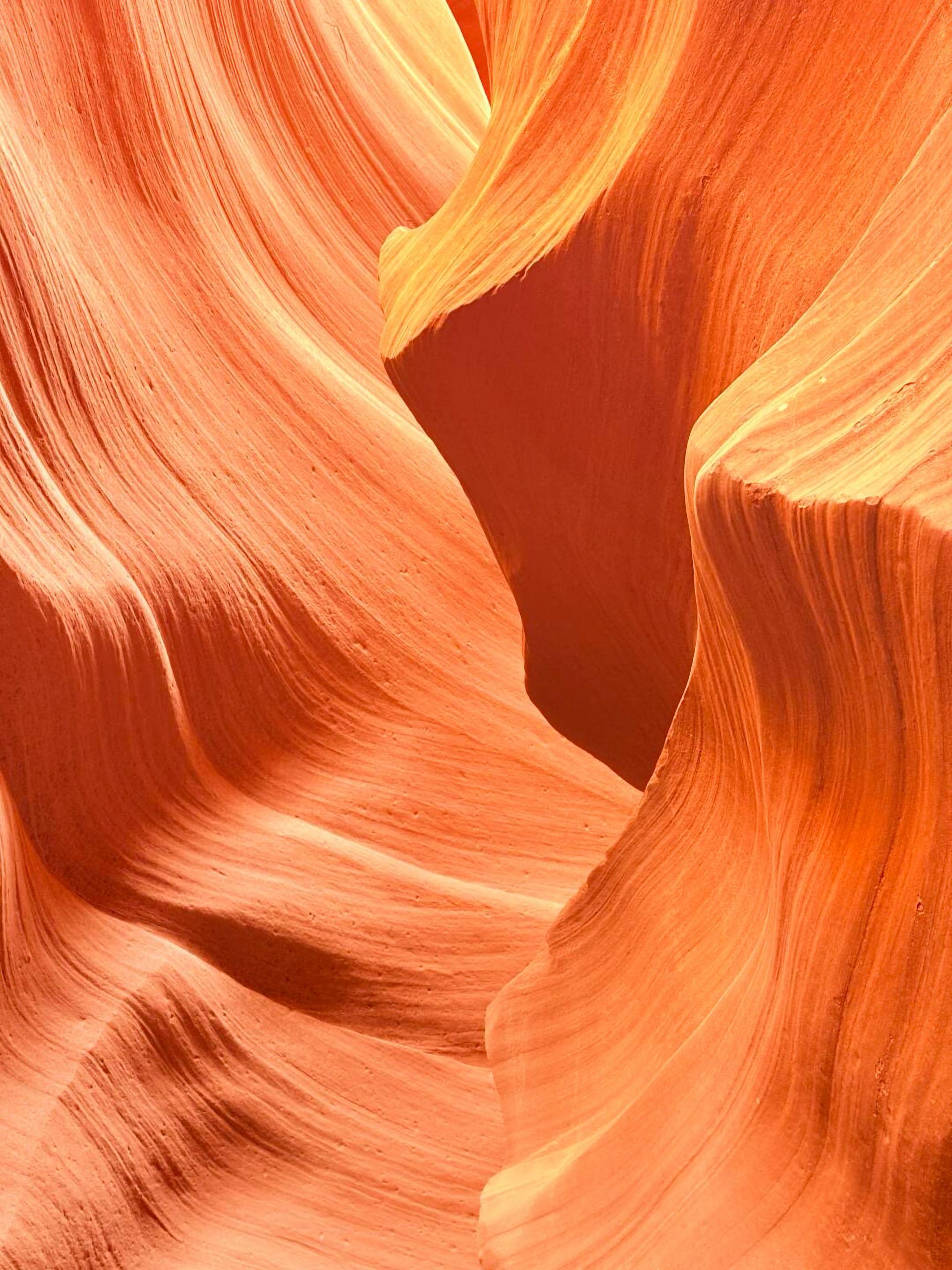 Water is running down a drain in a bathroom sink.