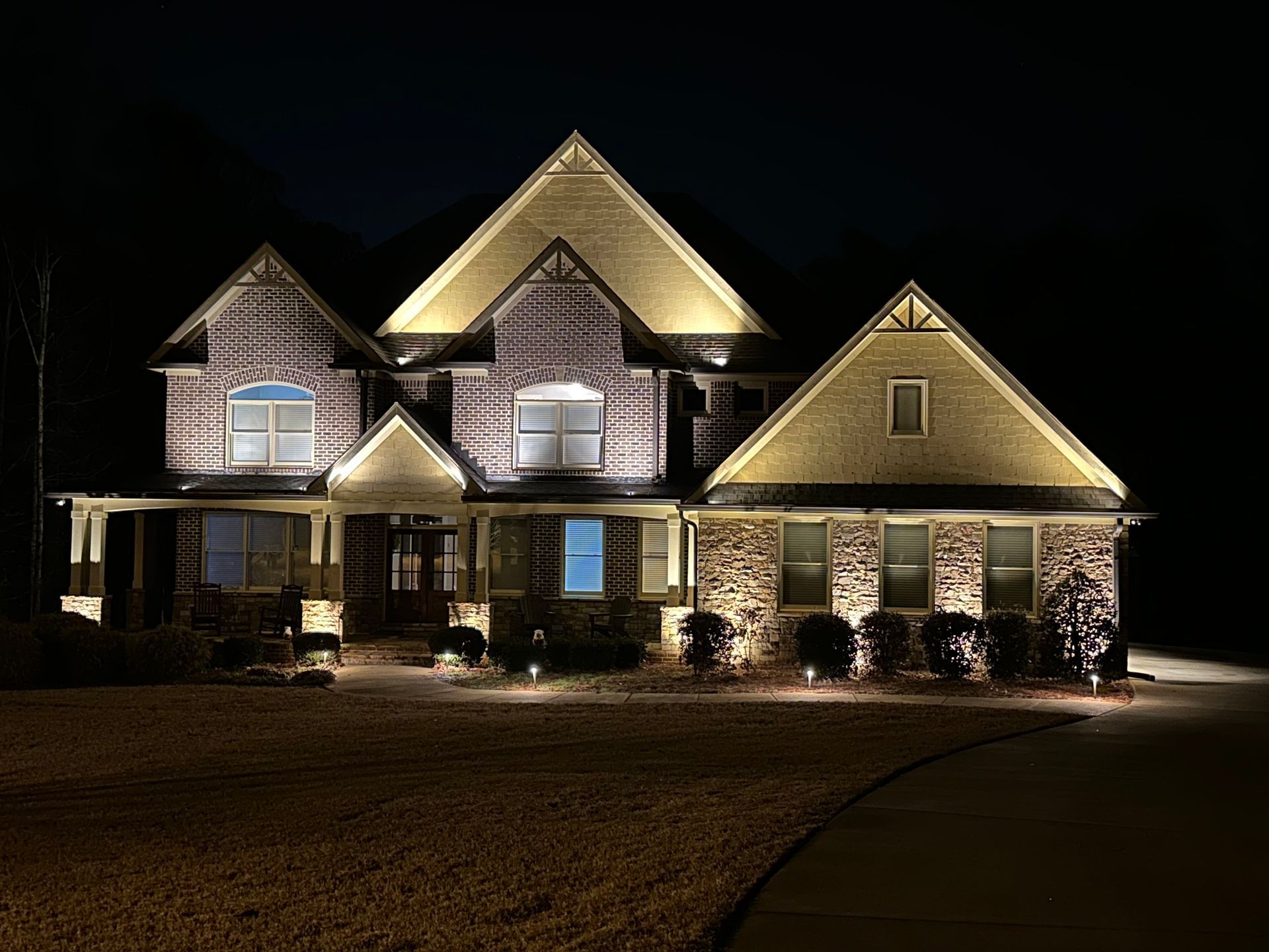 Modern two-story home with detailed, professional lighting package installed