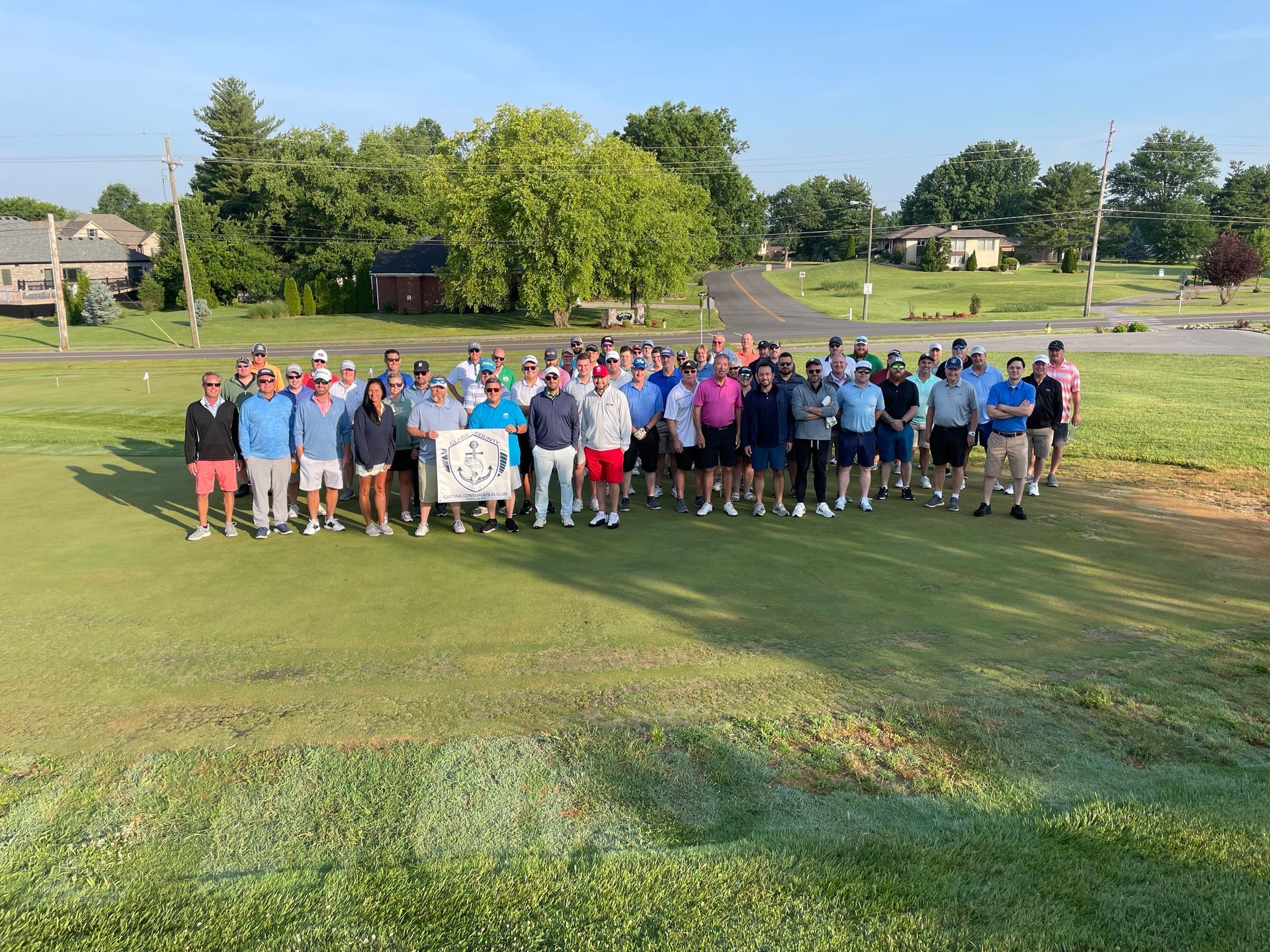 Hands holding a fishing pole with the lake in the background