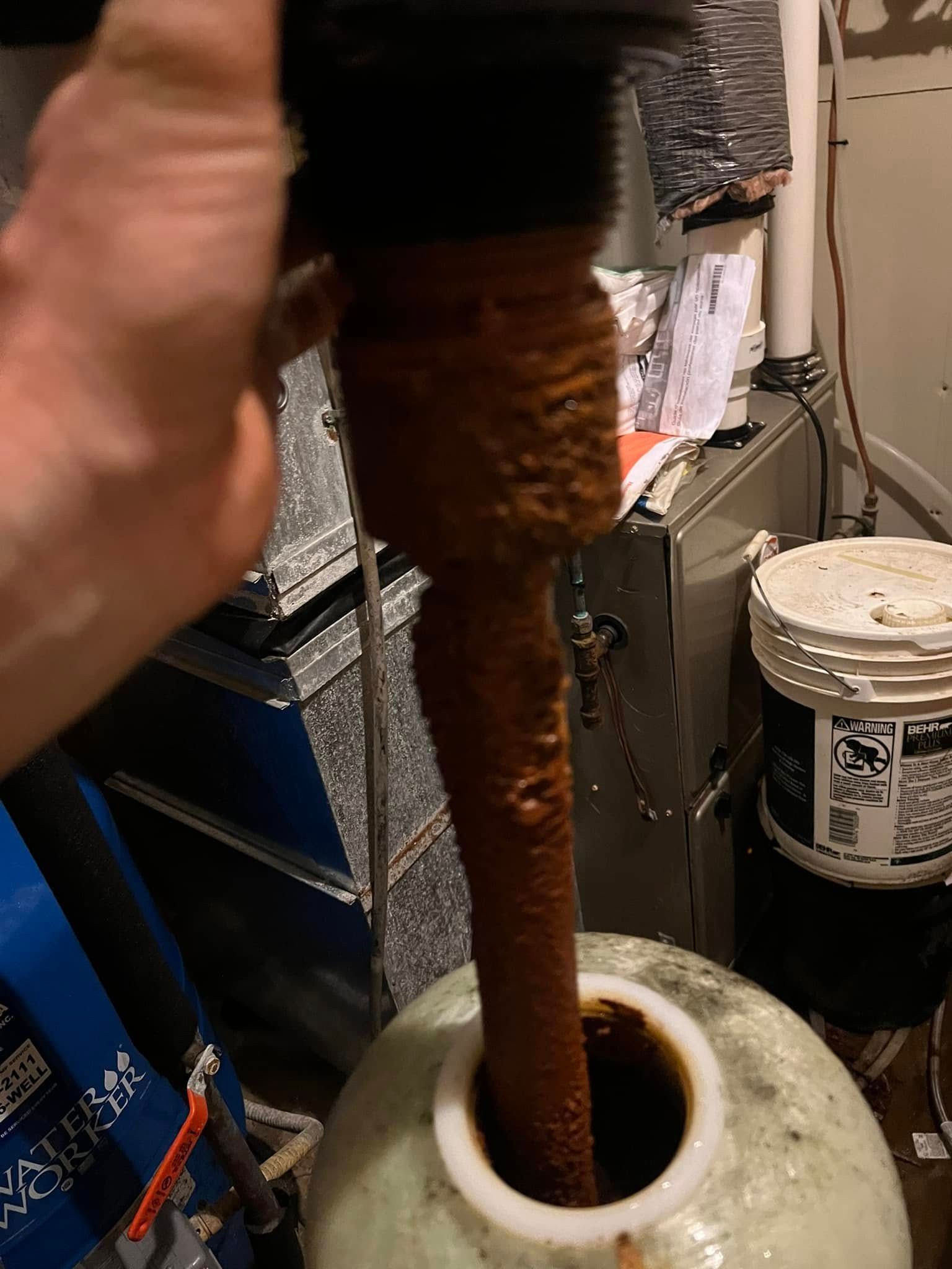 A person is pouring water from a faucet into a tank.