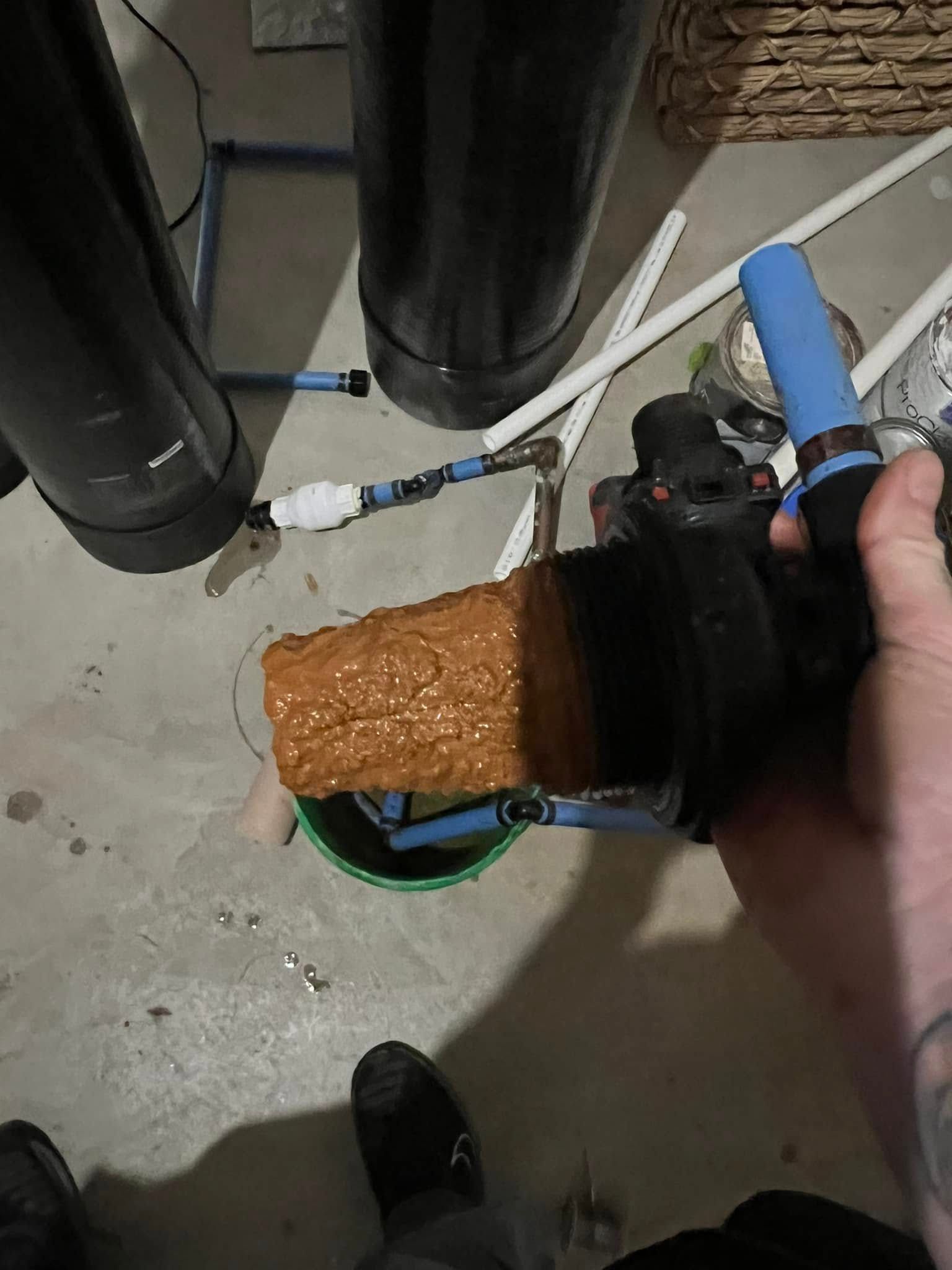 A person is holding a piece of wood in their hand.