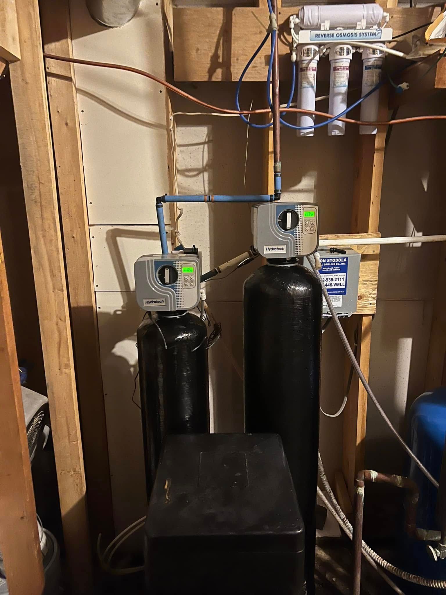 A water filter system is being installed in a basement.