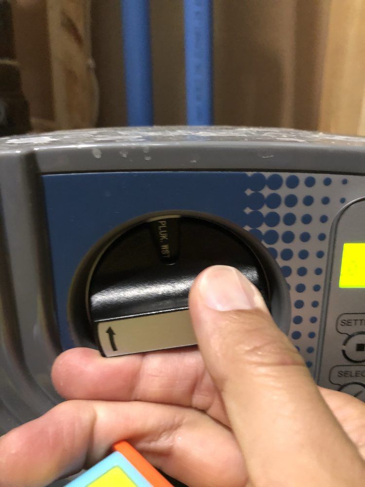 A close up of a person pressing a button on a device