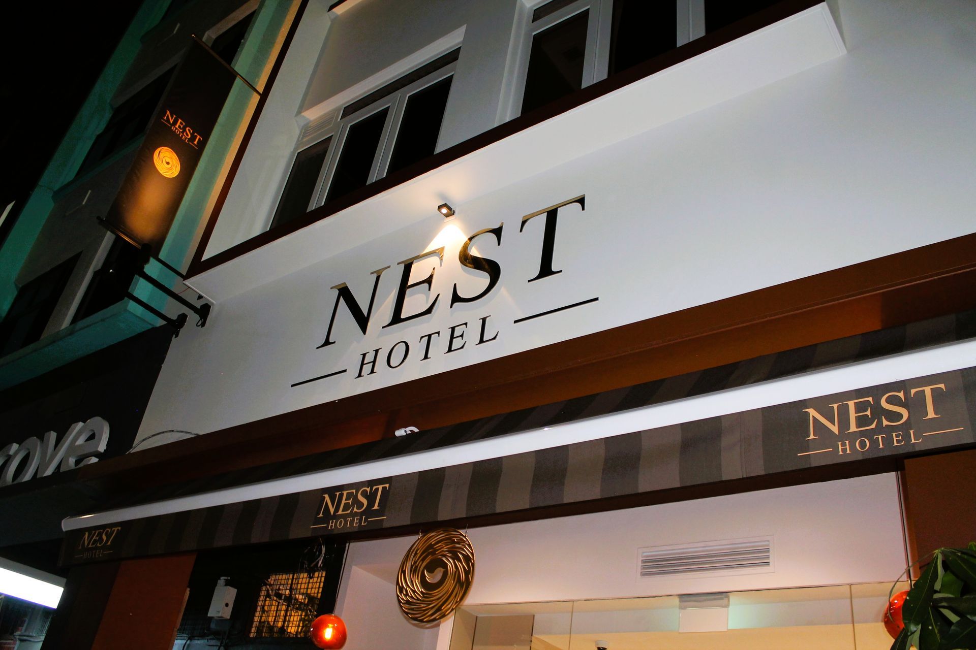 A building with a sign that says nest hotel