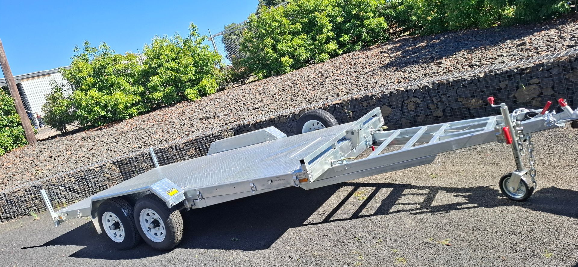 A Silver Car Trailer With Three Wheels is Parked Outdoors — Towform Trailers in Cobar, NSW