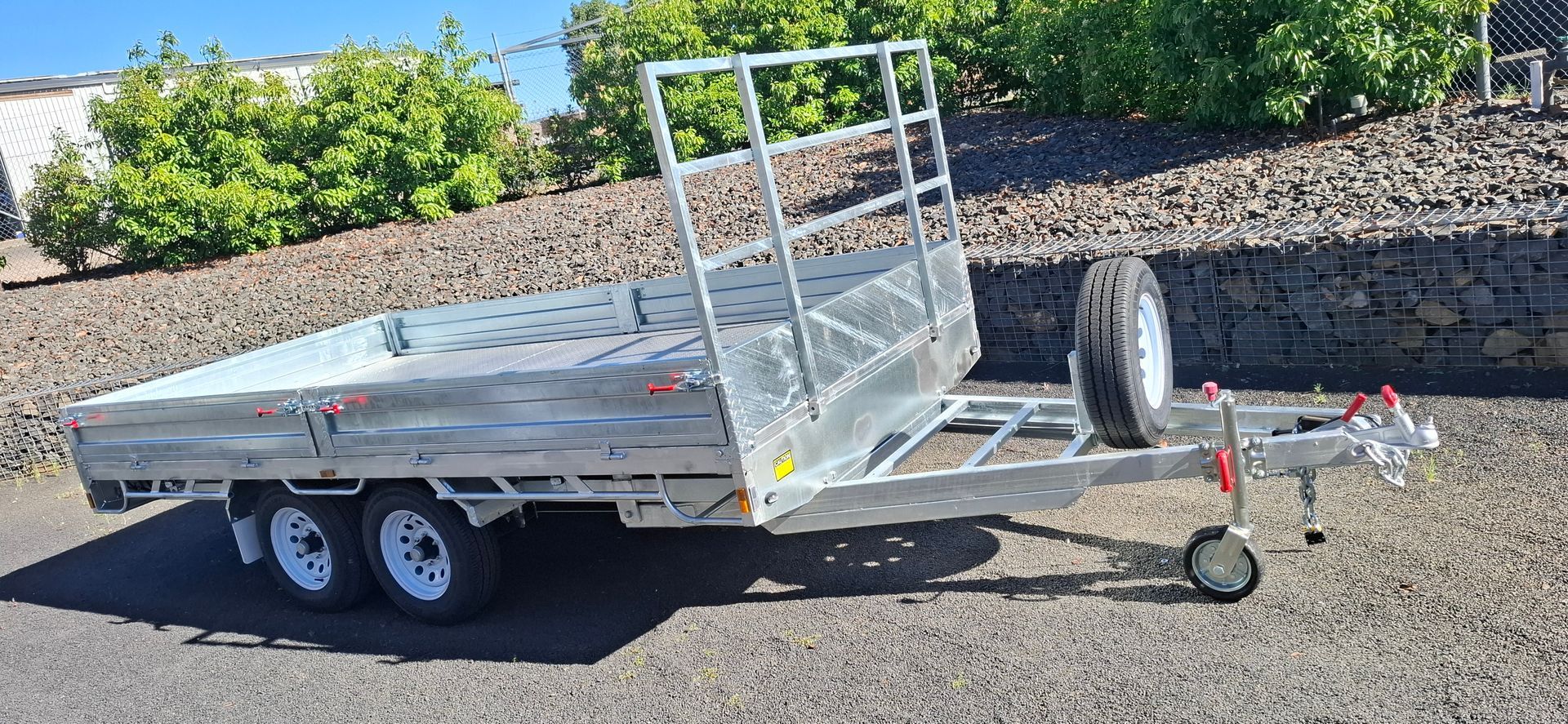 A silver utility trailer with two wheels, spare tire — Towform Trailers in Brocklehurst, NSW