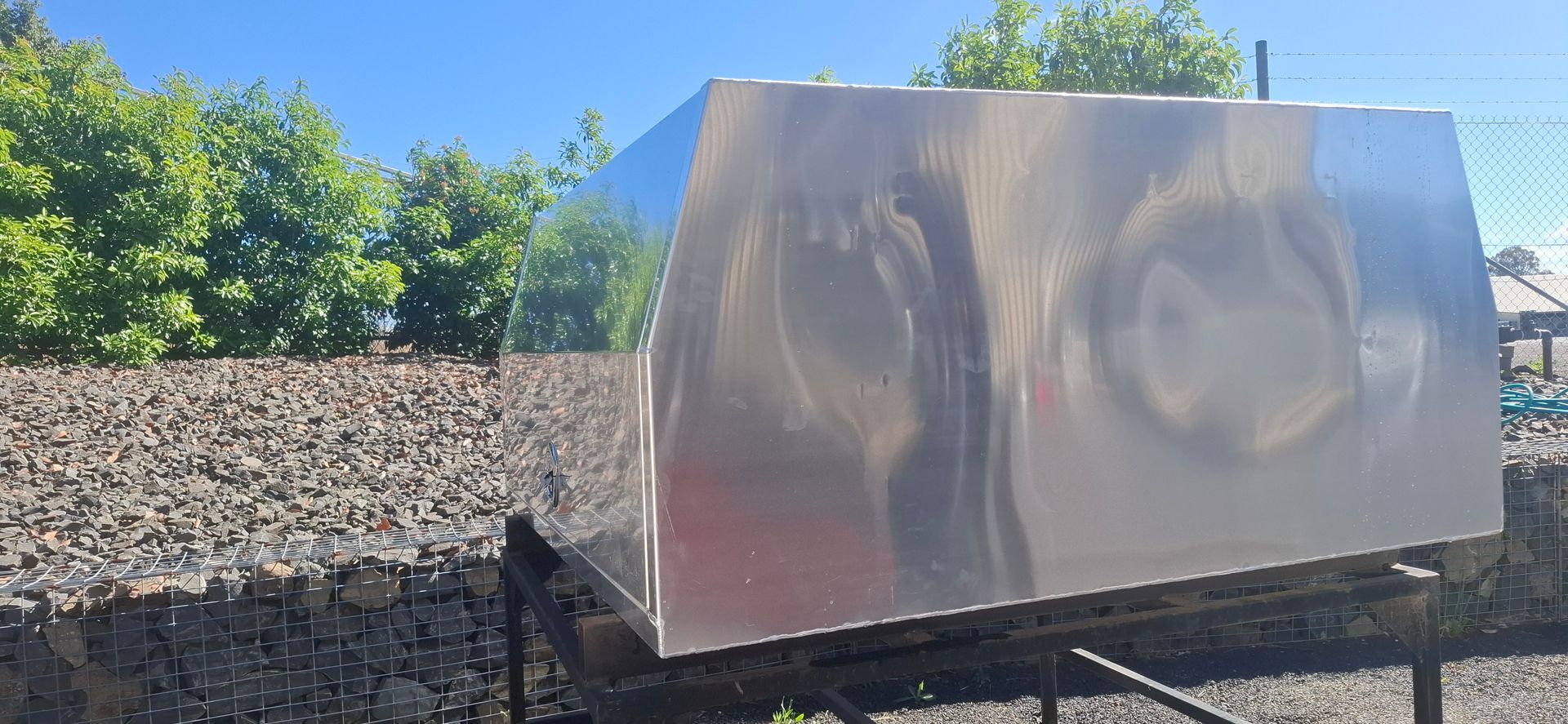 Shiny metal rectangular object on a black stand — Towform Trailers in Brocklehurst, NSW