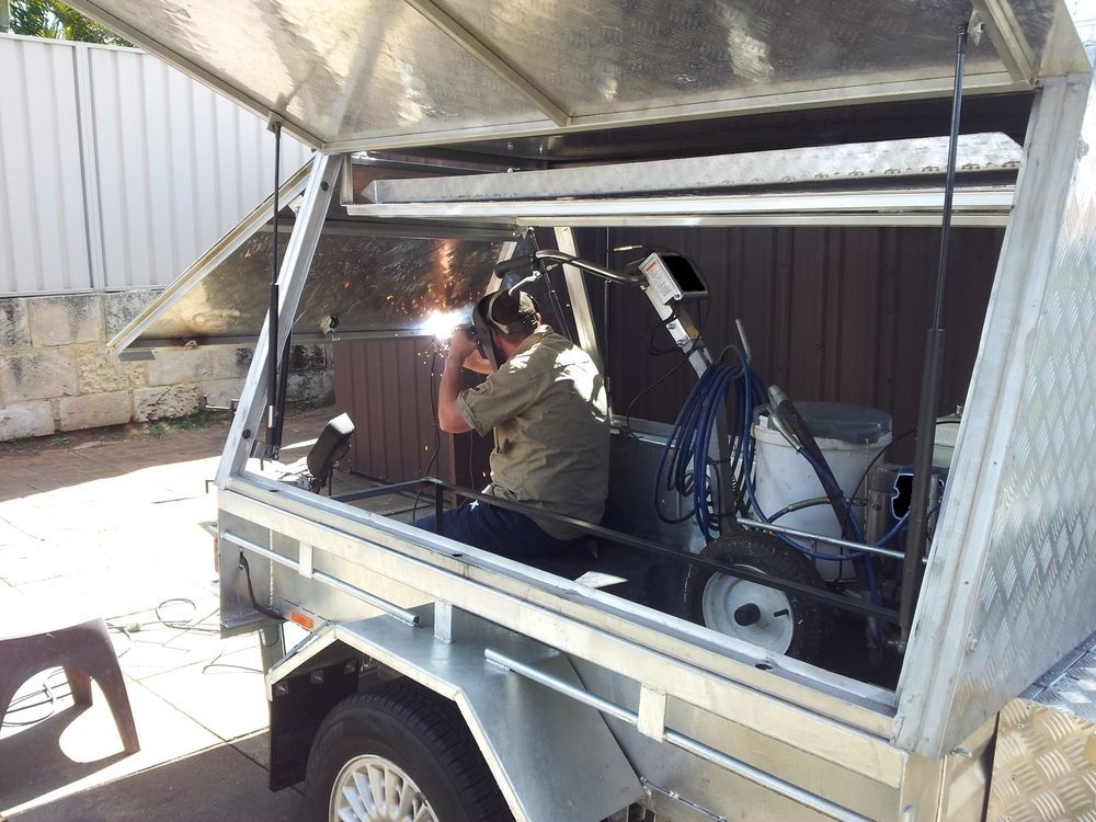 Person Welding Inside a Trailer, Sparks Flying — Towform Trailers in Brocklehurst, NSW