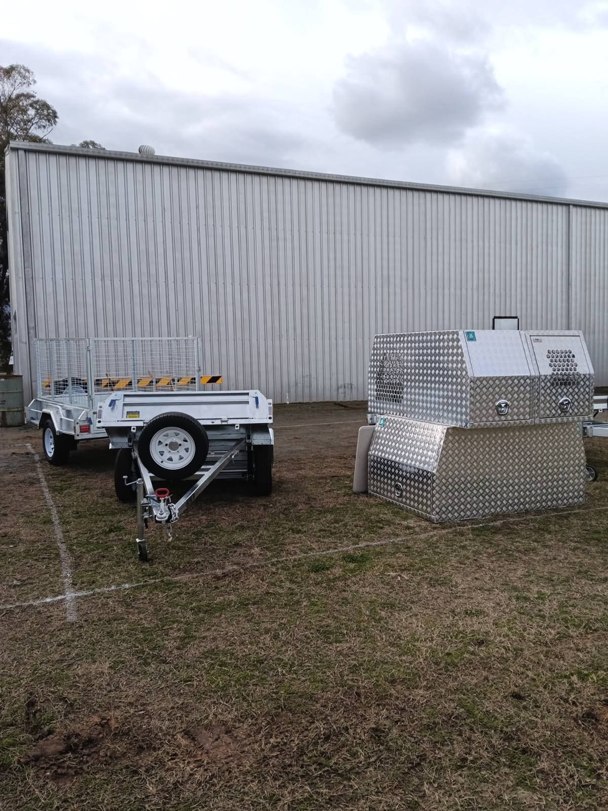 White Trailer and Aluminum Storage Units on Grass — Towform Trailers in Narromine, NSW