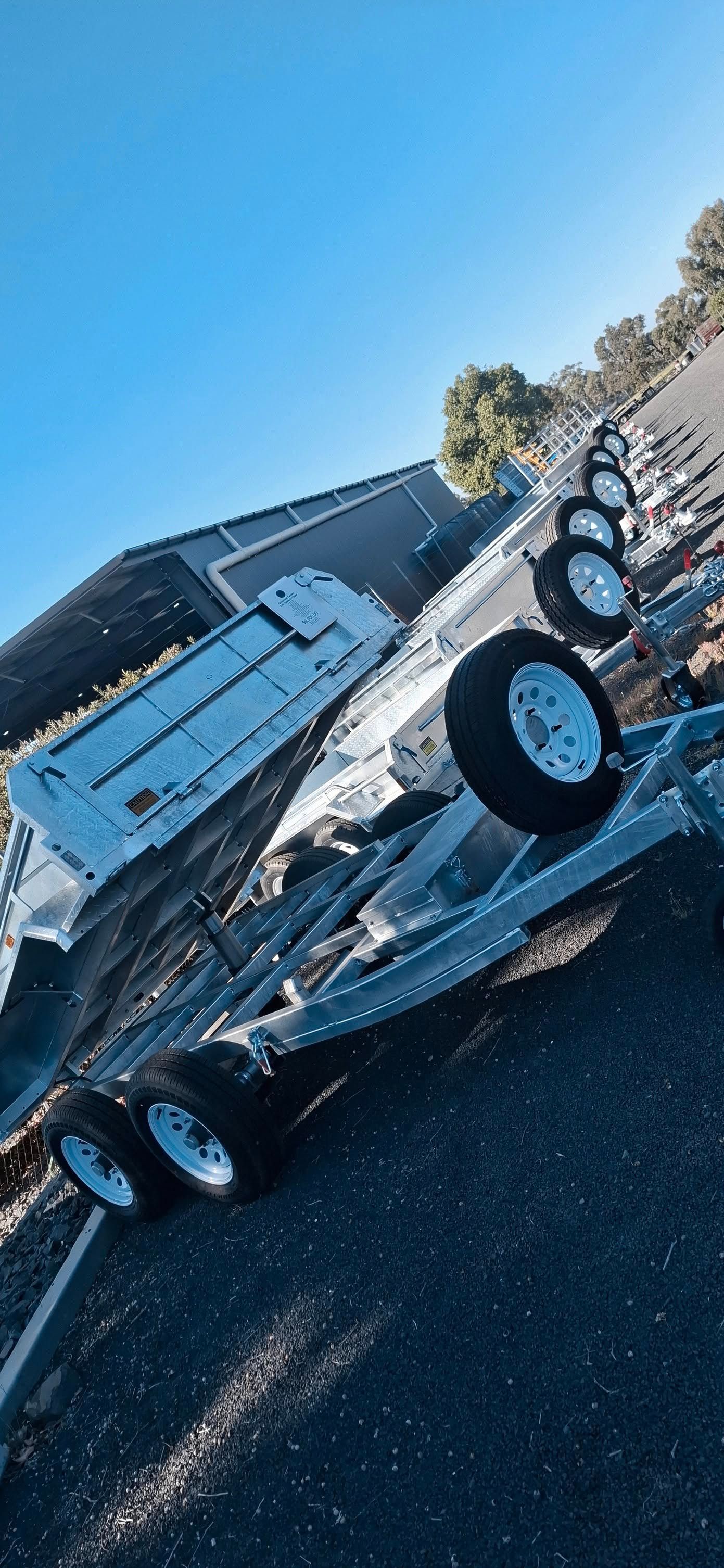 A Boat Trailer Overturned on a Dark Road Under a Bright Blue Sky — Towform Trailers in Gilgandra, NSW