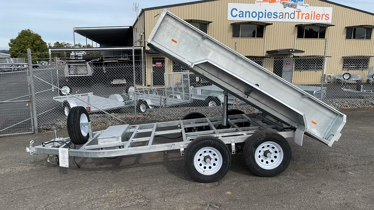 Silver Utility Trailer With A Raised Bed, Parked Outside A Building — Towform Trailers in Narromine, NSW