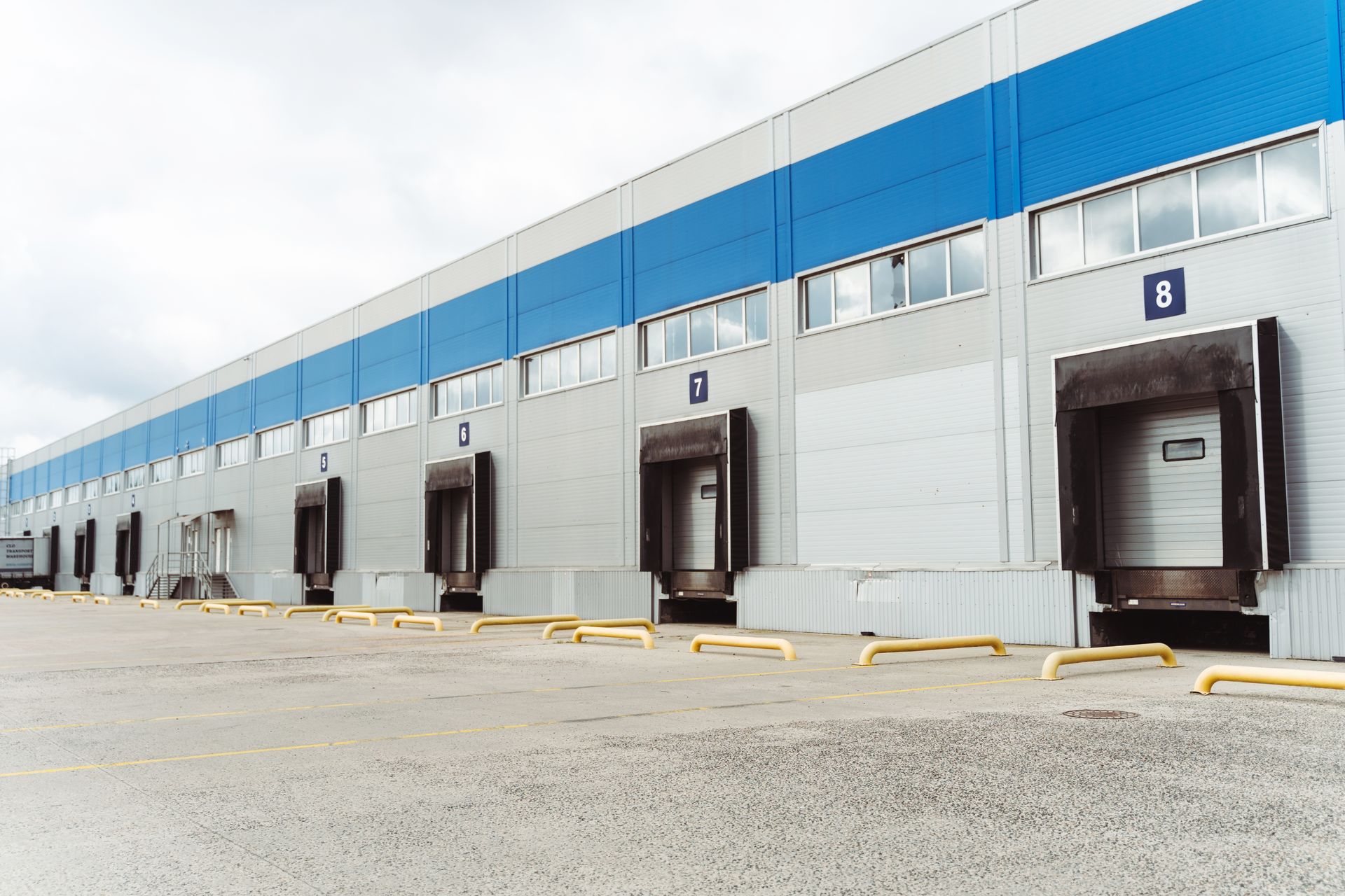 A large warehouse building with a lot of loading docks