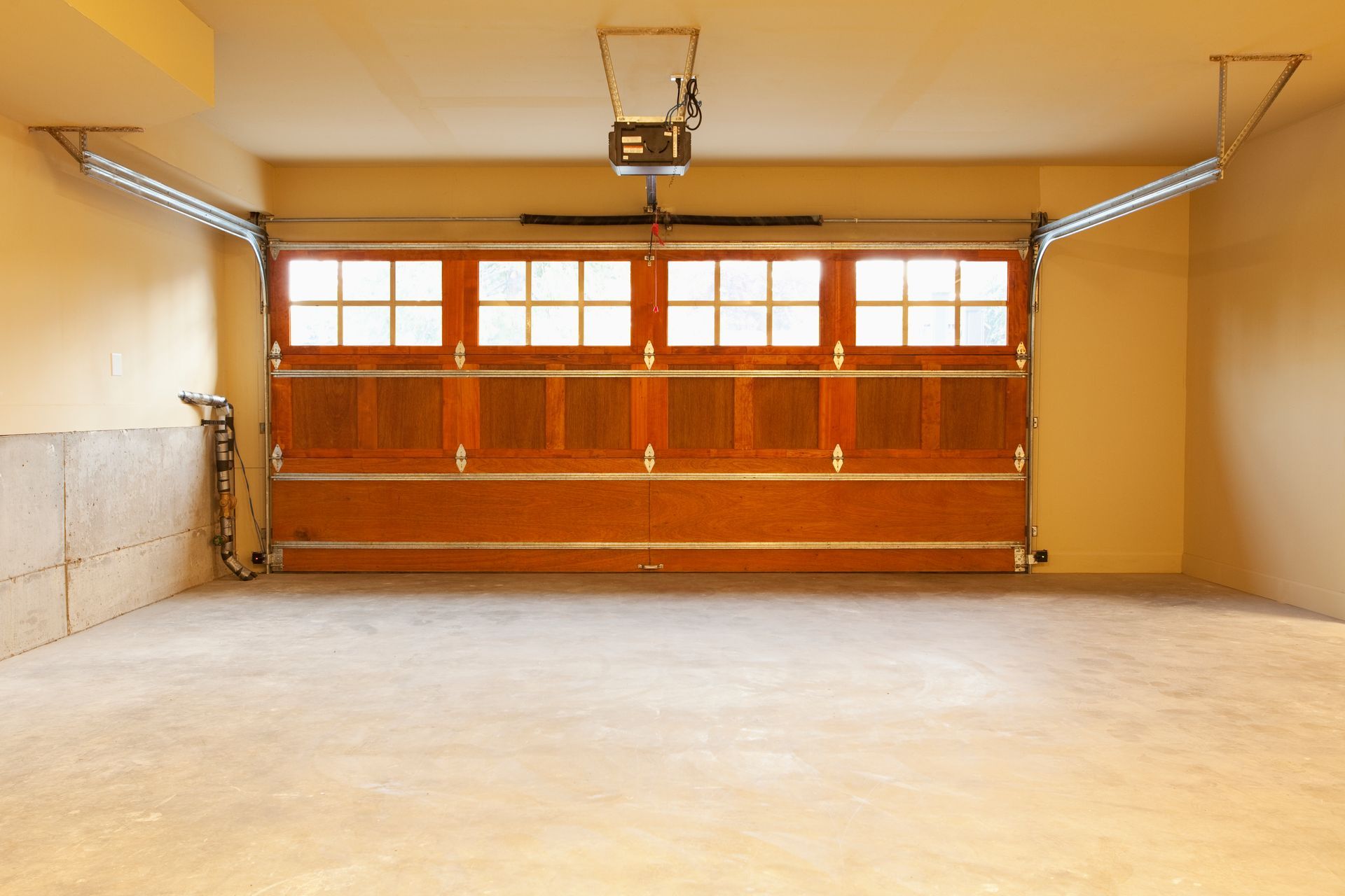An empty garage with a large wooden garage door
