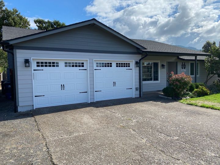 A garage with columns and a wooden door