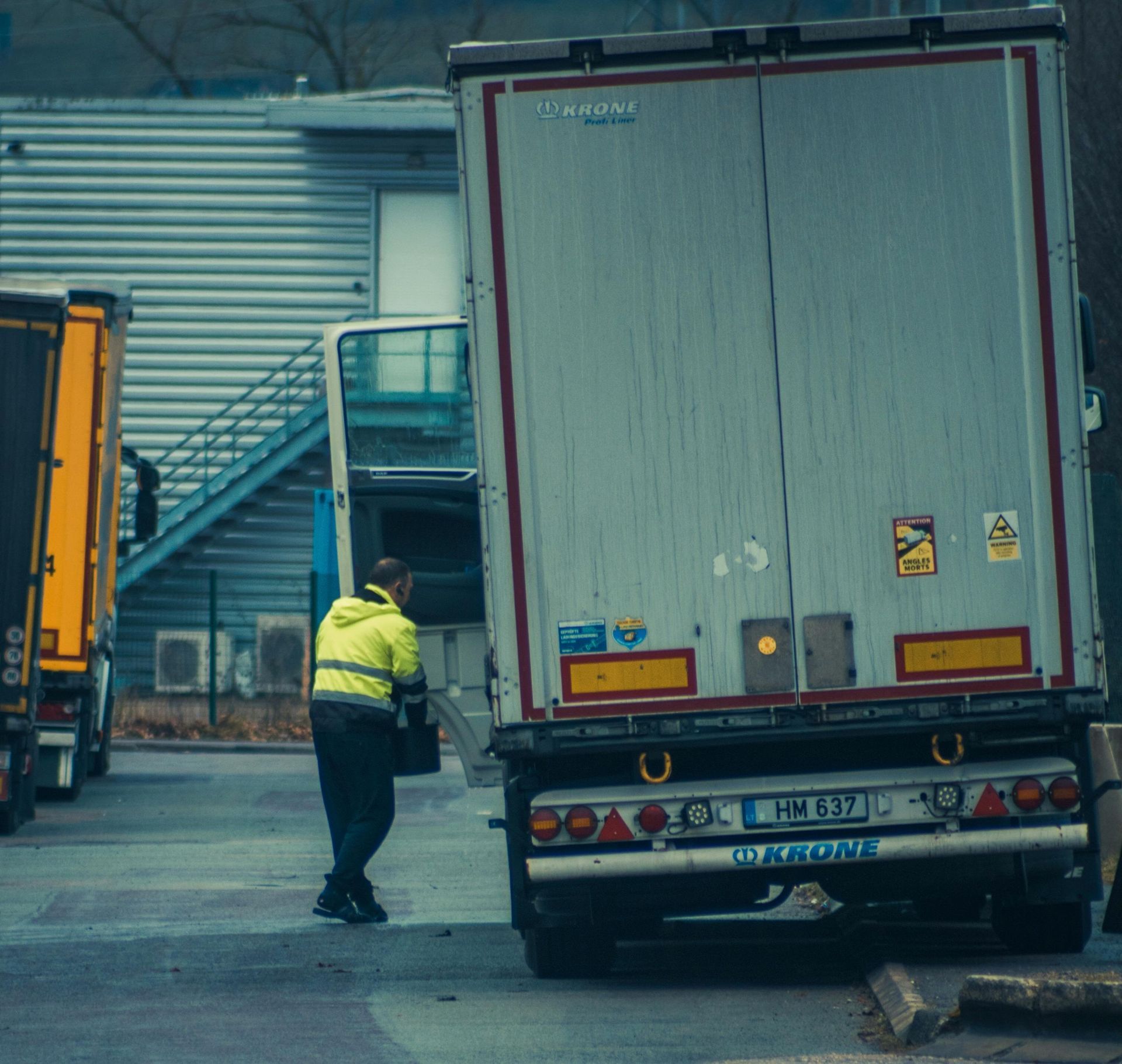 A worker loading a truck trailer without a dock leveler