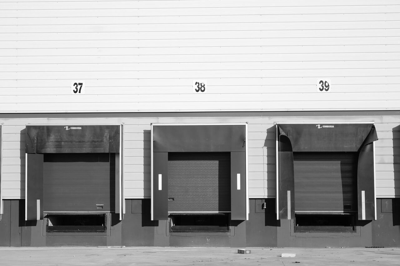 A black and white photo of a warehouse with loading docks