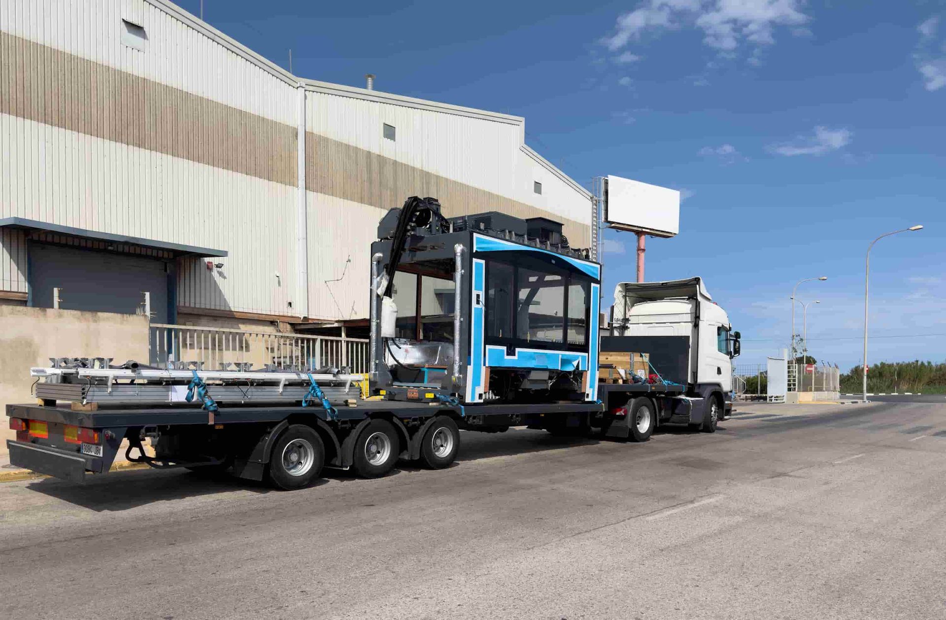 A Truck With a Crane on the Back of It is Parked in Front of a Building — Bowen Mechanical & Haulage in Bowen, QLD