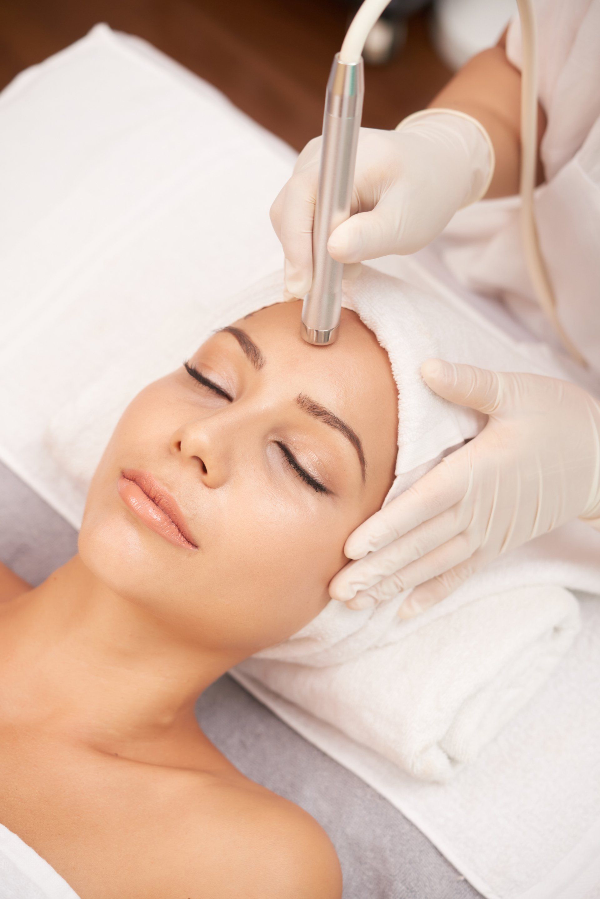 Woman receives facial treatment