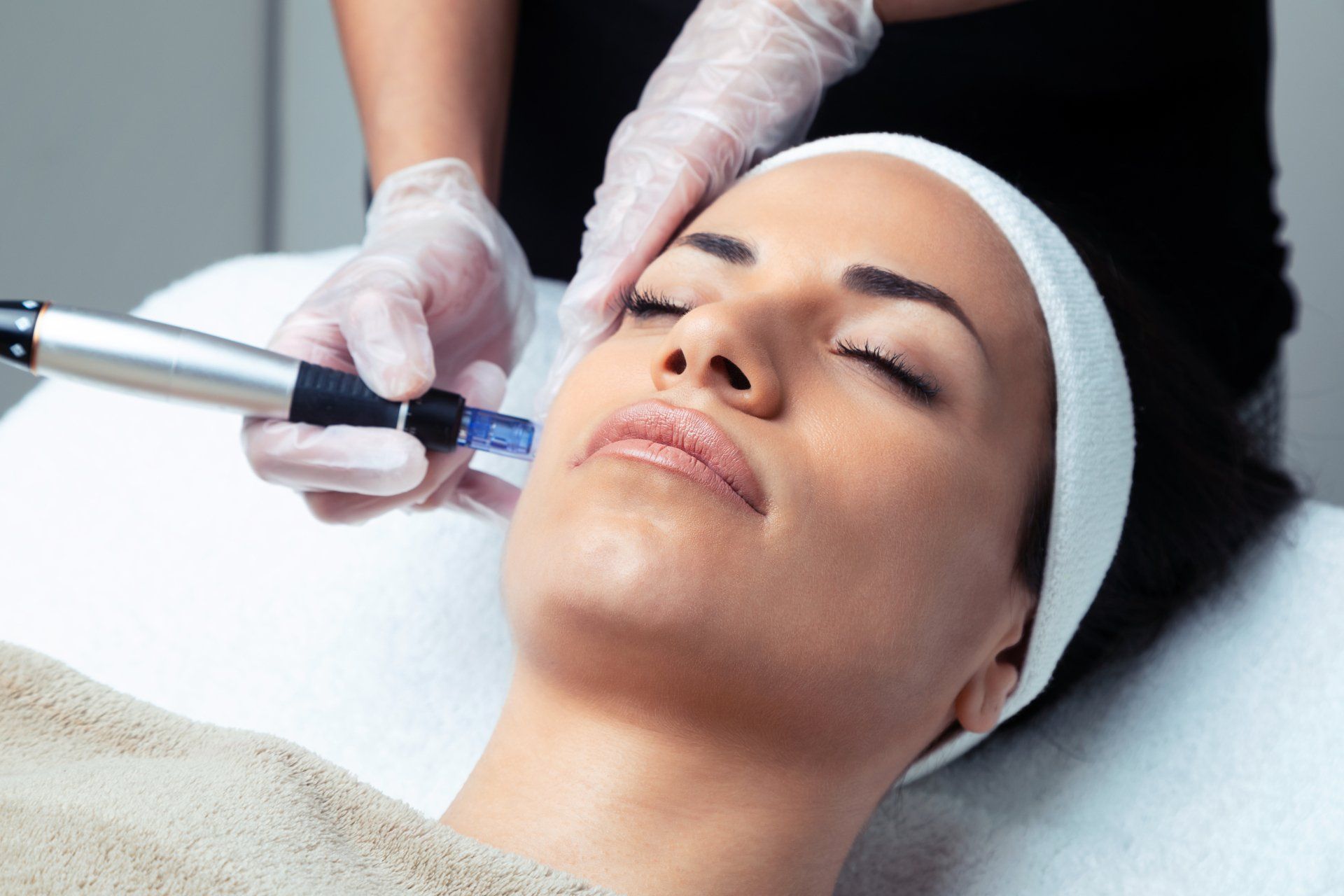 Woman receives microdermabrasion treatment