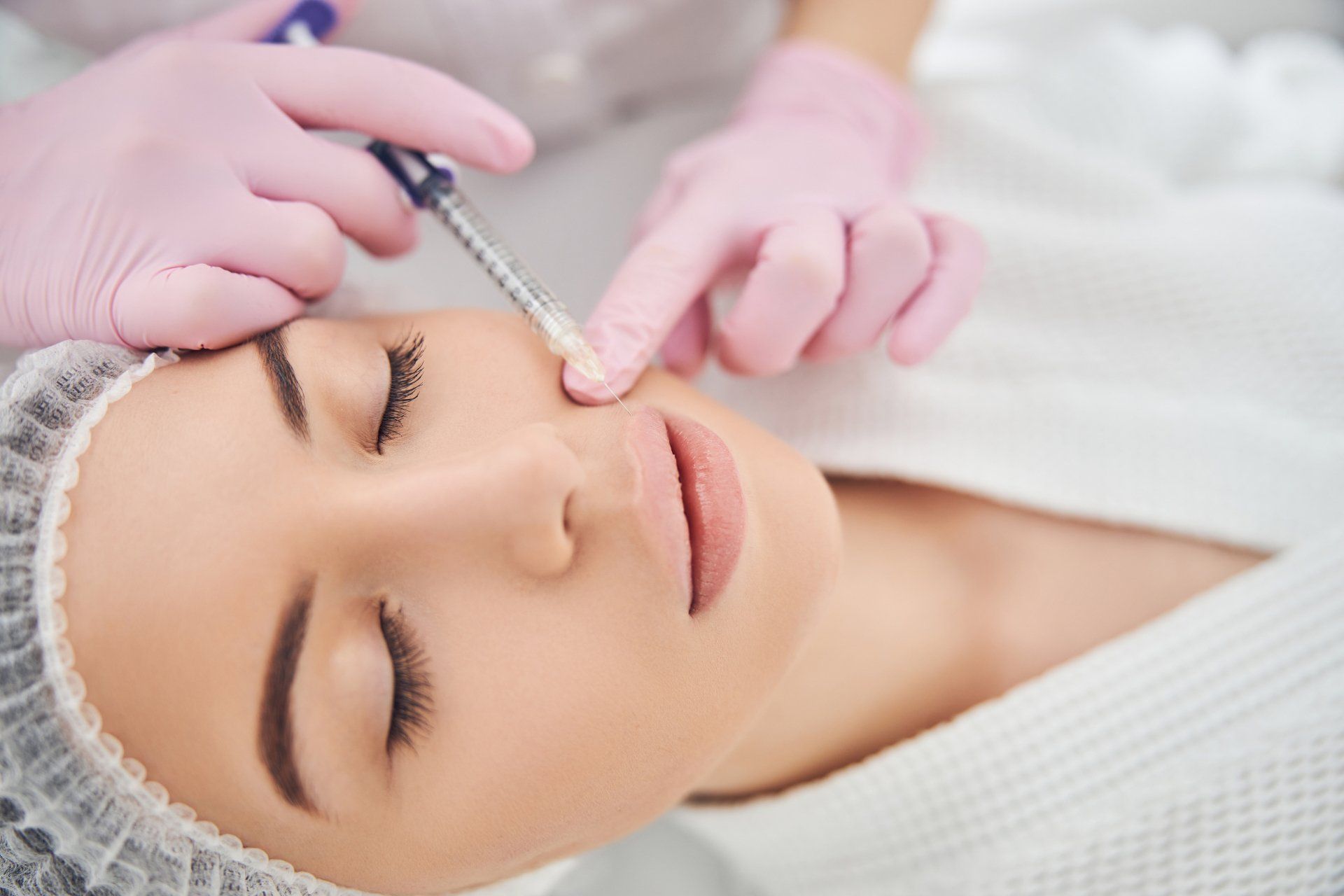 Woman getting a dermal filler injection