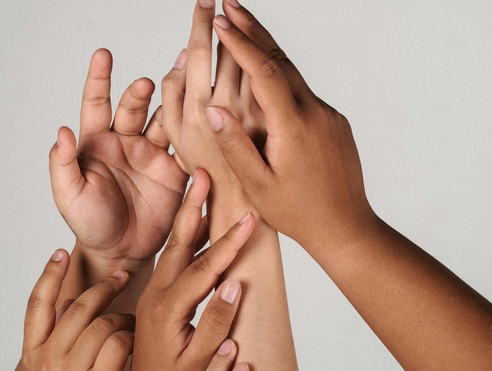 A group of people 's hands are stacked on top of each other