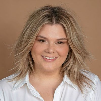 A man in a suit and tie is smiling for the camera.