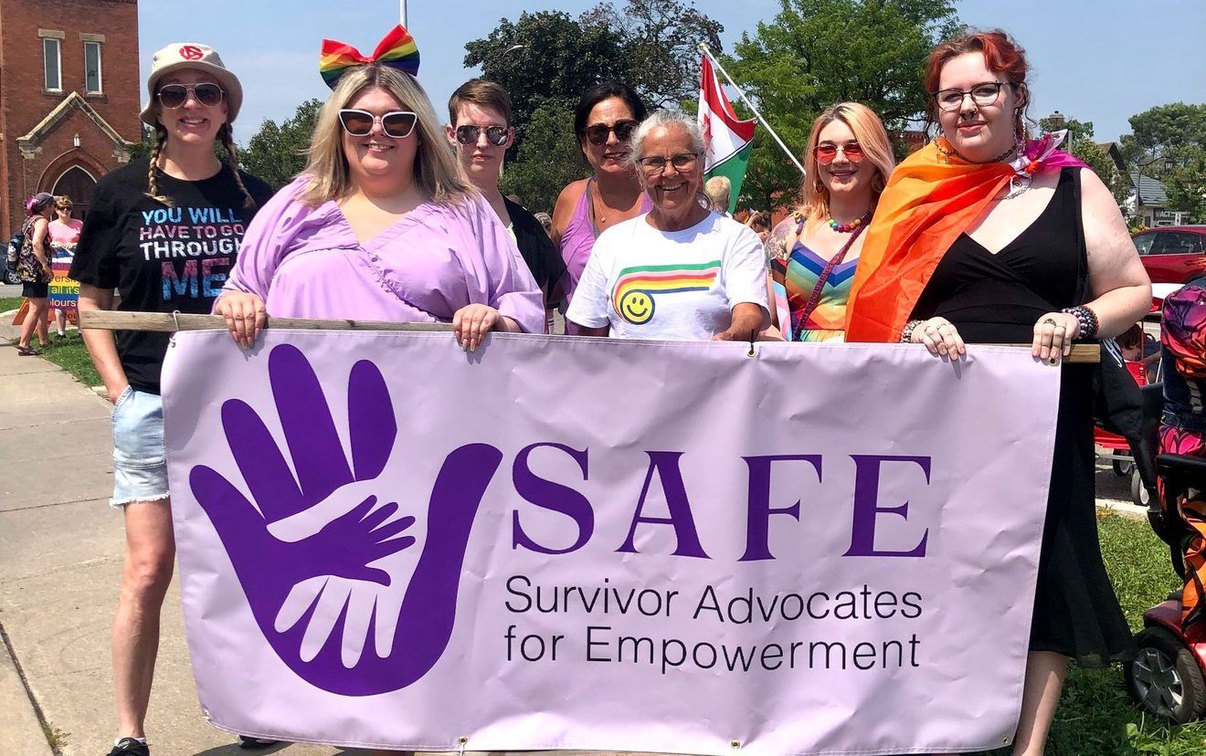 A group of women holding up signs that say safe