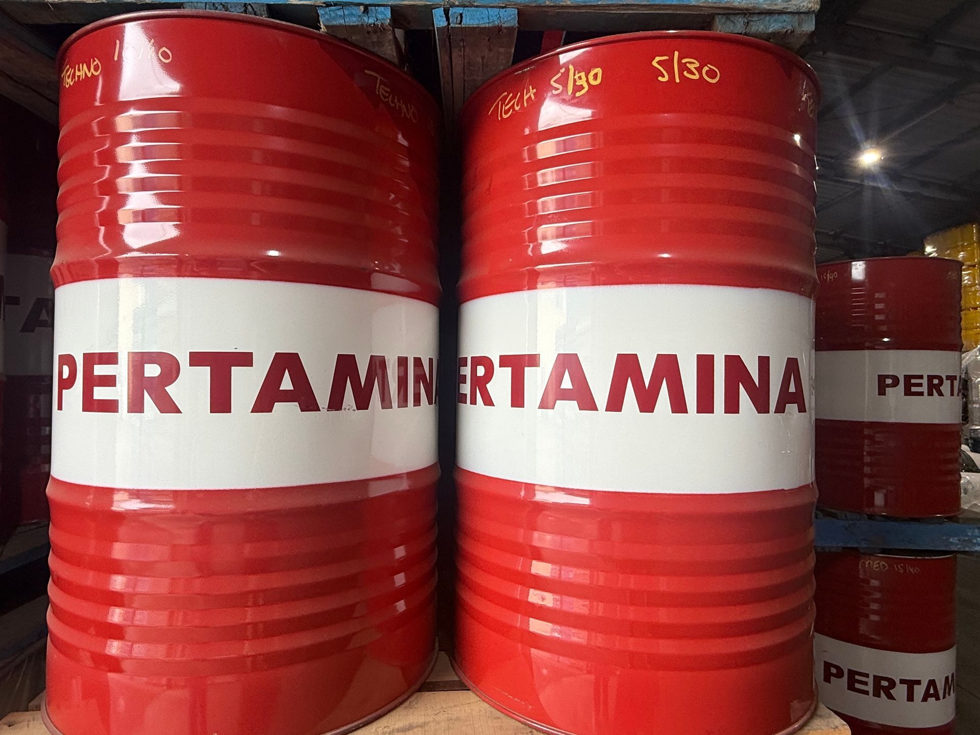 Red and white oil barrels labeled
