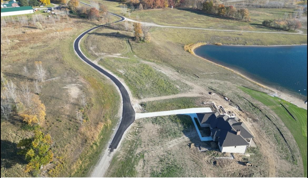 An aerial view of a road leading to a lake.