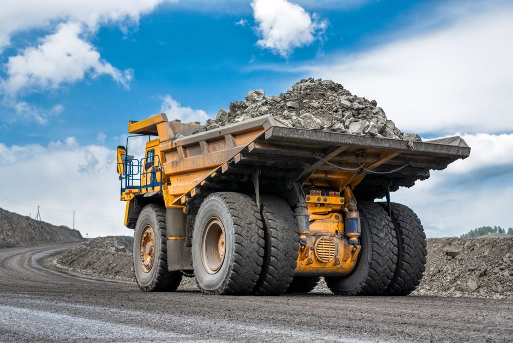 Mining Truck Loaded With Rocks Driving Along The Mountain — PBC Compliancing Pty Ltd in Whitsundays, QLD