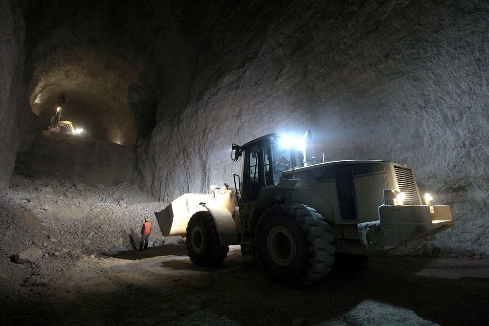 A Bulldozer Is Driving Down a Dirt Road in A Cave — PBC Compliancing Pty Ltd in Mackay, QLD