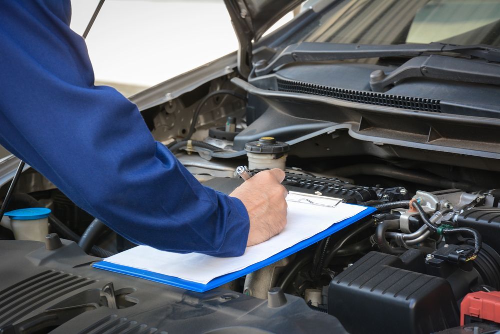Man Checking Car Engine In The Garage — PBC Compliancing Pty Ltd in Moranbah, QLD