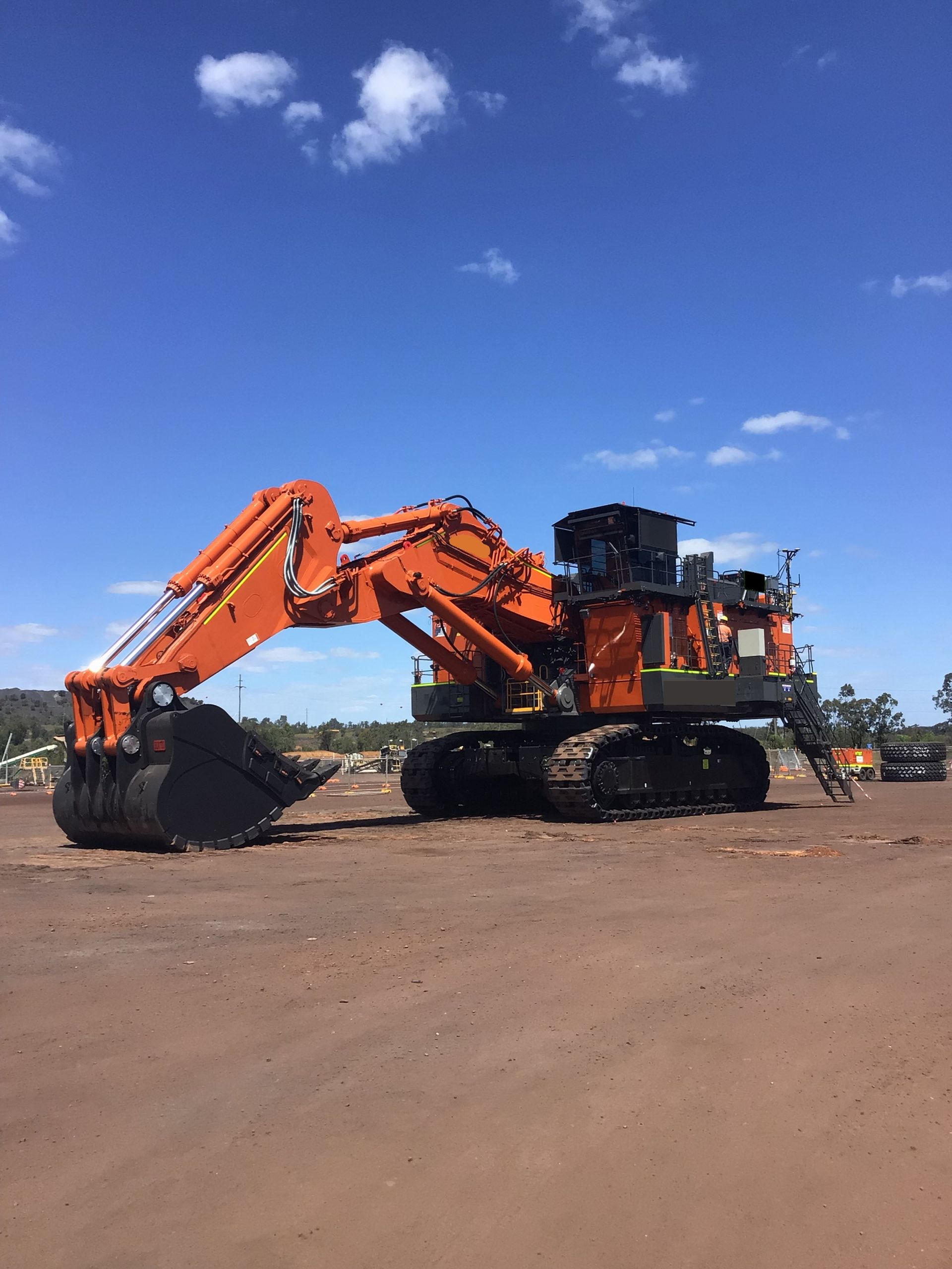 Large Orange Excavator on Tracks in An Open — PBC Compliancing in Paget, QLD